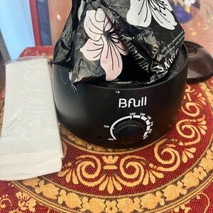 Black home waxing kit with supplies